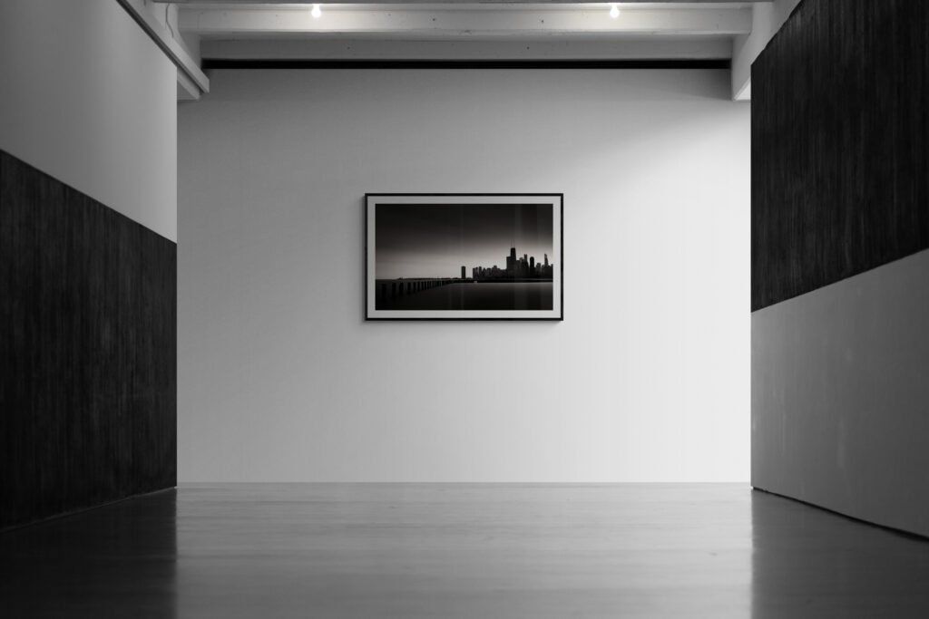 mockup of a framed photographic print hanging on a gallery wall
